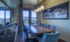 a dining room with a table and a couch at Edgemont 2401 - Luxury Ski-in Ski-out Condo in Steamboat Springs