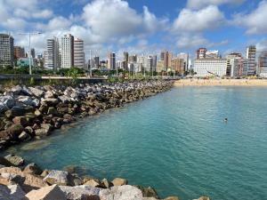 a view of a beach with a city in the background at Pousada da Celma in Fortaleza
