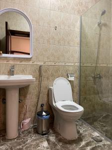 a bathroom with a toilet and a sink and a shower at مقر الفخامة in Abha +22 photos