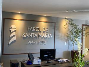 an office with a large sign on a wall at Residence Farol - Loft 213 in Laguna