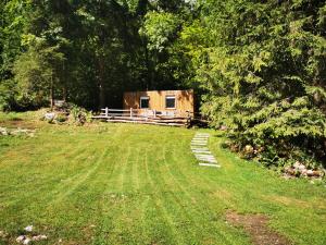 a small cabin in the middle of a grass field at Skalca in Kamniška Bistrica +16 photos