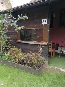 a house with a window and a sign on it at Apartman Anika in Moravice