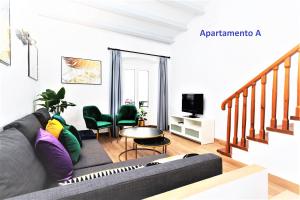 a living room with a couch and a table at Sitges Rustic Apartments in Sitges