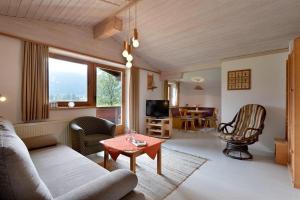 a living room with a couch and a table at APARTMENTS Pension Foidl in Oberndorf in Tirol