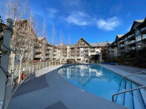 a large swimming pool in front of a building at Best ski in ski out condo at Whistler in Whistler