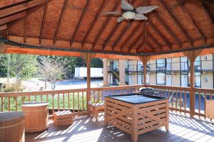 an outdoor pavilion with a ceiling fan and a table at Super 8 by Wyndham Marion NC in Marion