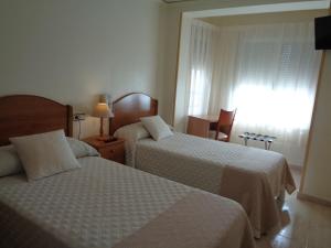 Postel nebo postele na pokoji v ubytování Hostal El Retiro