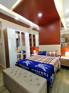 a bedroom with a bed with a blue comforter at Antara Residentials and Condominium in Talisay