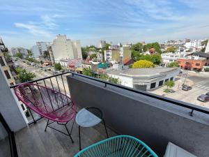 a balcony with chairs and a view of a city at Days Inn Devoto in Buenos Aires
