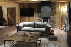 a living room with a couch and a table at Maison de village au coeur d'Allos in Allos