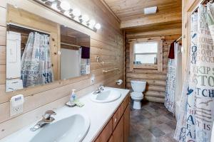 a bathroom with a sink and a toilet and a mirror at Ruby Peak Haven in Joseph +16 photos