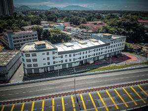 a large white building on the side of a road at Reno Hotel Ipoh in Ipoh
