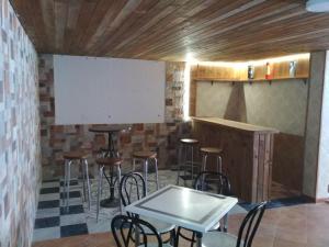 a bar with stools and a whiteboard in a room at La Huerta - VuT AV187- para 10 personas in Poyales del Hoyo