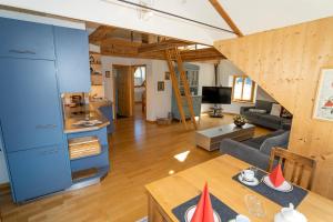 a living room with a couch and a table at Apartment Bügl Grond 124 in Scuol