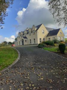 a large white house with a driveway at Bedroom No 3 Garden view in Nobber