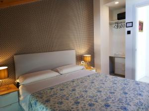 a bedroom with a large bed and two lamps at sweet homes in Lecco