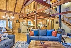 a living room with a blue couch and a table at Massanutten Resort Log Cabin with Mountain Views! in McGaheysville