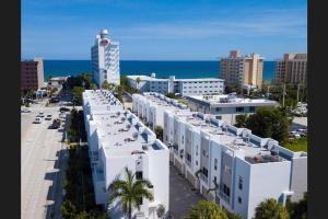 an aerial view of a city with white buildings and the ocean at Across the Ocean few steps to beach contemporary three Bedroom townhouse in Pompano Beach