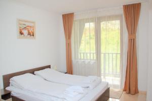 a bedroom with a bed and a large window at Гранд Манастира Апартаменти "Зимна приказка" in Pamporovo +31 photos