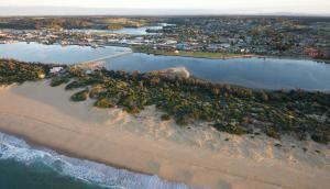 an aerial view of a beach and the ocean at Sandbar Motel in Lakes Entrance