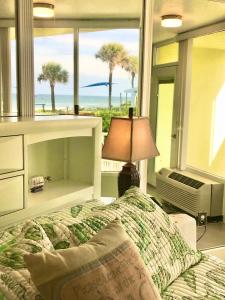 a bedroom with a bed with a view of the ocean at Just Beachy -Ocean View at Symphony Beach Club in Ormond Beach