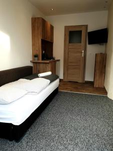 a bedroom with a bed and a wooden door at BoomerangHouse in Wrocław
