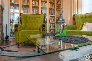 a living room with a green couch and a glass table at Agroturystyka Corno Owca in Żabnica