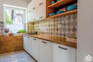 a kitchen with white cabinets and a window at Agroturystyka Corno Owca in Żabnica