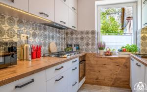 a kitchen with white cabinets and a counter top at Agroturystyka Corno Owca in Żabnica