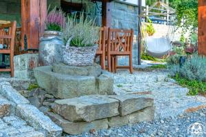a garden with some plants in a basket on some rocks at Agroturystyka Corno Owca in Żabnica