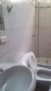 a bathroom with a toilet and a shower and a tub at HOSTAL MONUMENTAL a Media Cuadra de la Plaza Mayor in Cajamarca