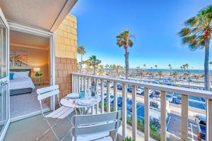 a balcony with a bed and a view of the beach at Balboa Pier House in Newport Beach