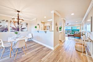 a dining room and living room with a table and chairs at Balboa Pier House in Newport Beach
