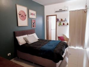 a bedroom with a bed and a door to a room at Star house in Foz do Iguaçu