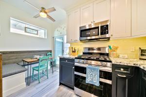 a kitchen with a stove top oven next to a table at Mission Beach Getaway Condo in San Diego