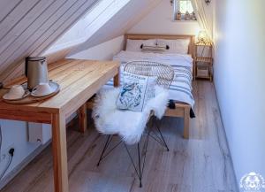a bedroom with a bed and a wooden table at Agroturystyka Corno Owca in Żabnica