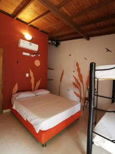 a bedroom with a bed and a wall with fish painted on it at Villa del Sol Hotel & Restaurante in Villavieja