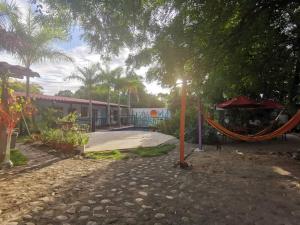 a park with a playground with a swing at Villa del Sol Hotel & Restaurante in Villavieja