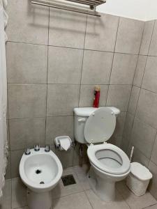 a small bathroom with a toilet and a sink at La Casa del Arbol - Ushuaia - JUMAX Travel in Ushuaia