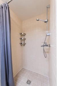 a bathroom with a shower with a shower curtain at Cozy place in Vilnius Old Town in Vilnius