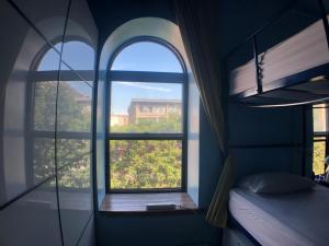 a bedroom with a window with a view of a building at Auberge Alternative in Montreal
