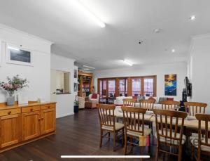 a dining room and living room with a table and chairs at Pemberton Lodge in Pemberton