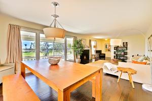 a living room with a wooden table and a couch at DP-343 - Dana Point Parkside Cottage in Capistrano Beach
