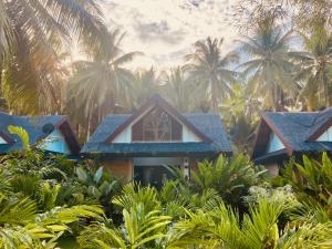 a house in the jungle with palm trees at The Village Siargao in General Luna