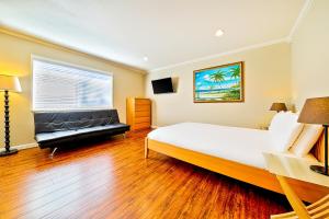 a bedroom with a large bed and a couch at Disney Getaway in Anaheim