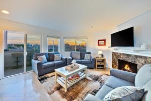 a living room with two couches and a fireplace at Newport Pier Townhome in Newport Beach