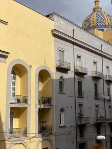 a building with balconies and a domed building at Cupola San Marcellino in Naples