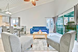 a living room with a blue couch and a table at Groundswell 4 Bedroom in Newport Beach