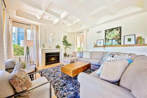 a living room with a couch and a fireplace at La Jolla Cove Beauty in San Diego