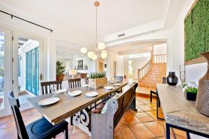 a dining room with a long table and chairs at La Jolla Cove Beauty in San Diego